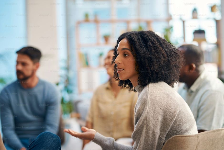 A woman speaking in a small support group