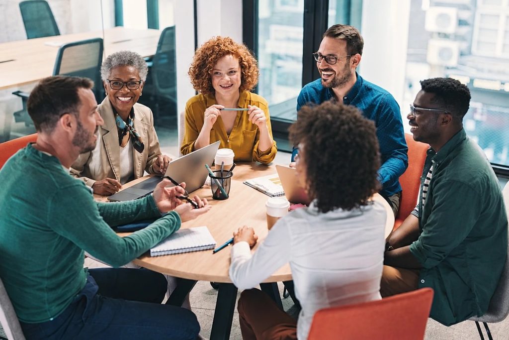 People talking around a table at a community workshop